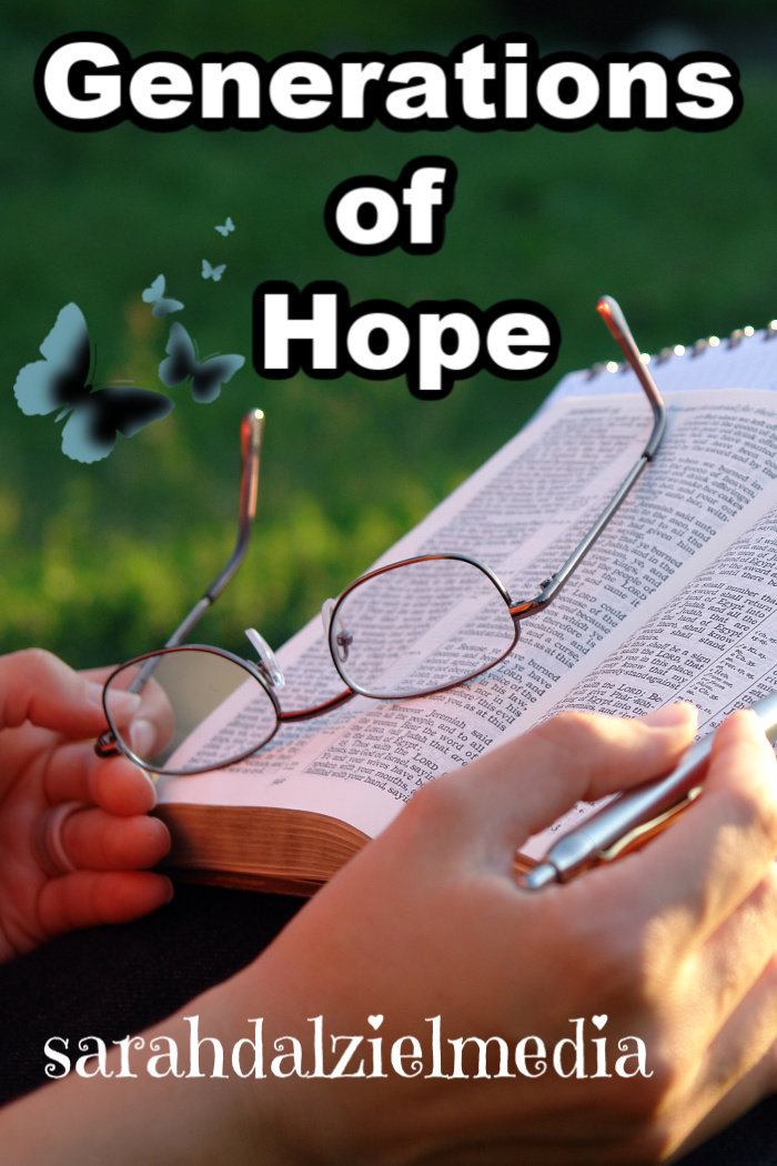 hands of a person with glasses and pen over an open bible